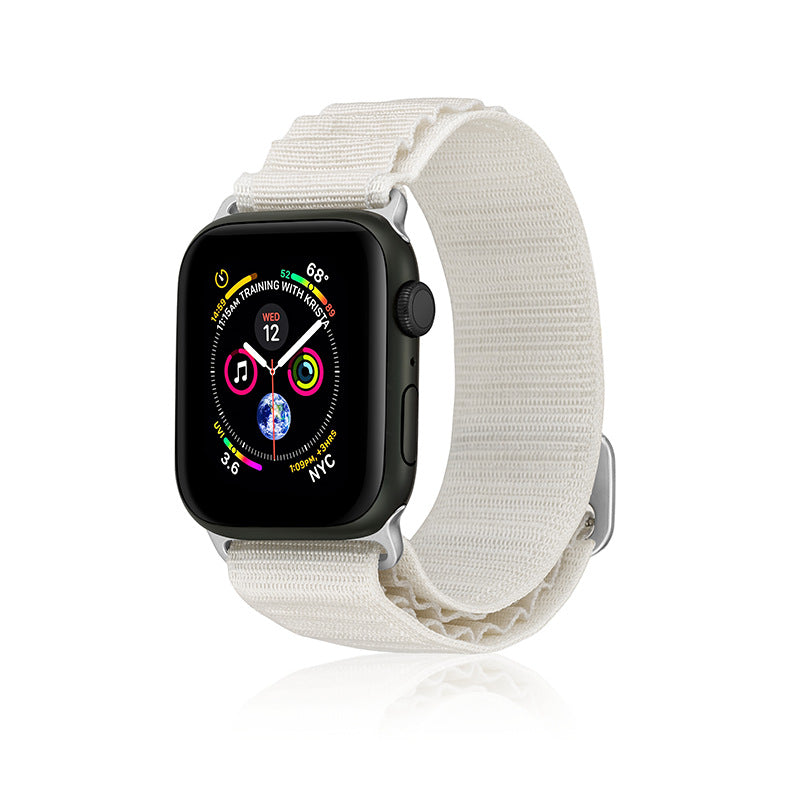 Black smartwatch with colorful fitness rings on display, white fabric Alpine Loop band with adjustable closure