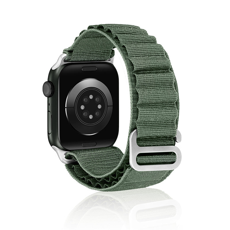 Black smartwatch with sage green woven Alpine Loop band and silver connector hardware