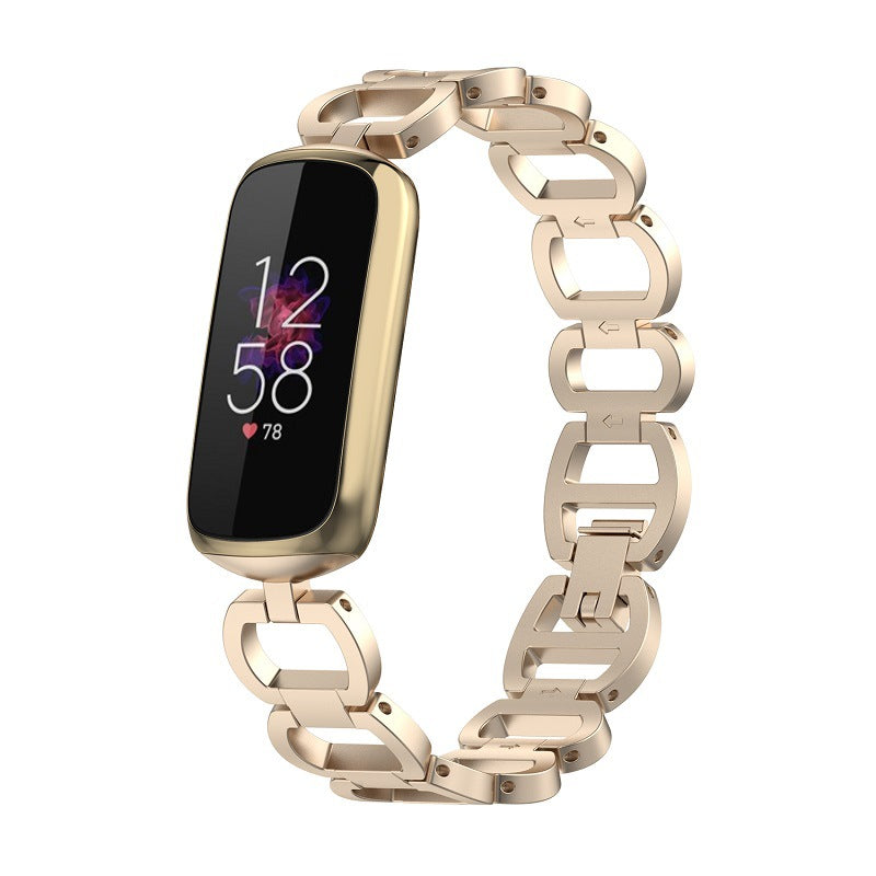 Gold stainless steel chain bracelet band for Fitbit Luxe fitness tracker with rectangular OLED display showing time and heart rate