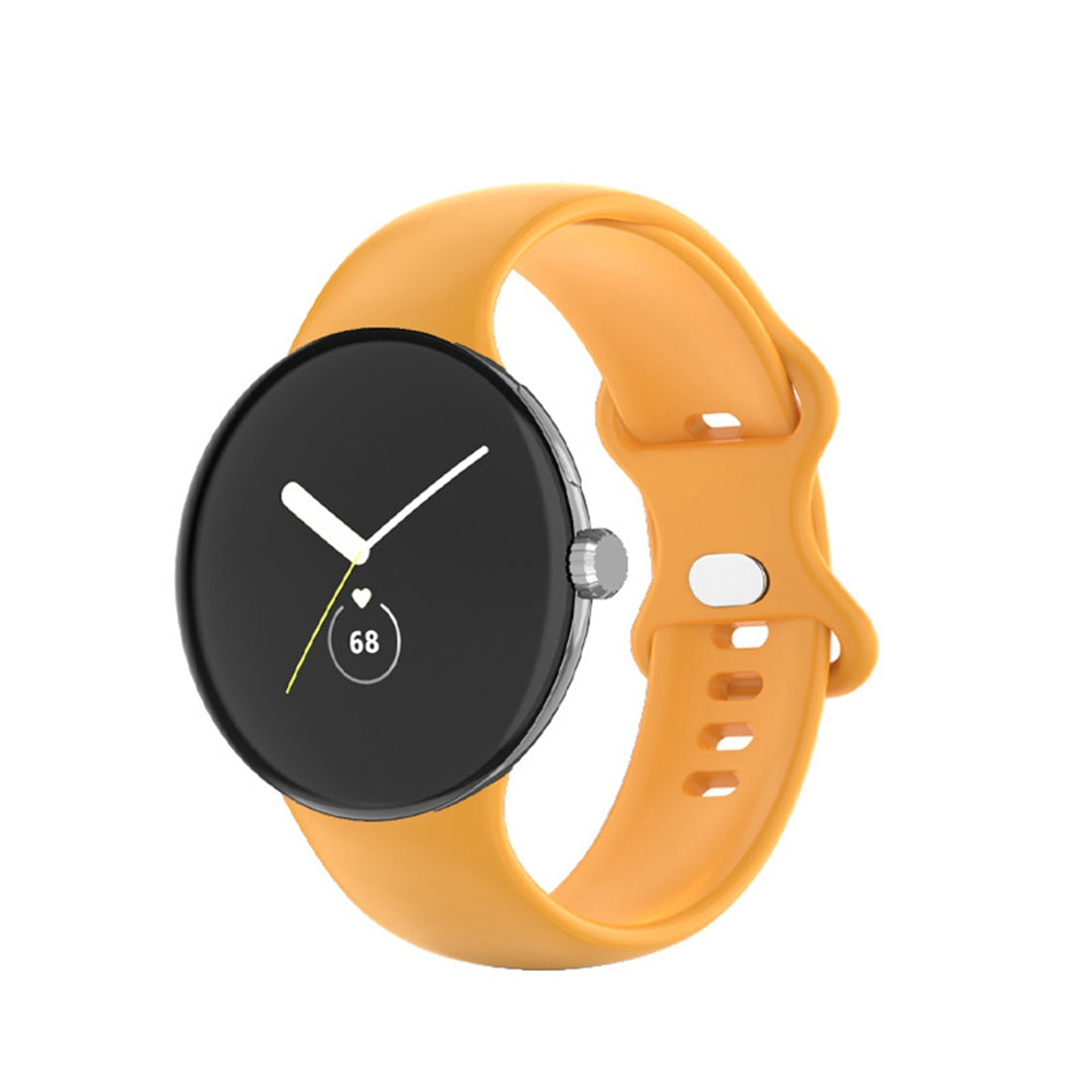 Google Pixel Watch with orange silicone band and black analog face displaying time and heart rate monitor