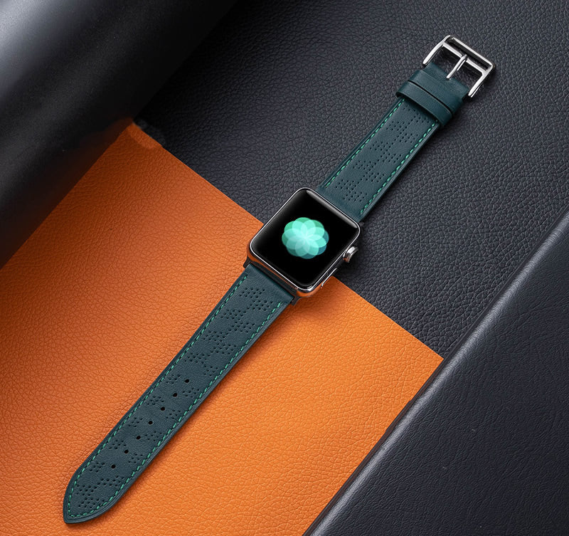 Apple Watch with forest green perforated leather single tour band on orange and gray textured background