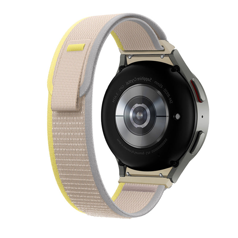 Galaxy Watch 4-7 Trail Loop band in cream and yellow nylon with titanium hardware on smartwatch