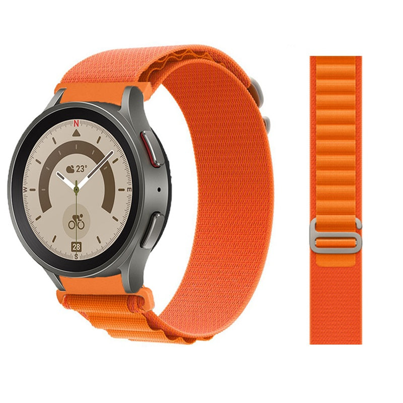 Samsung Galaxy Watch smartwatch with orange alpine loop band and titanium case, showing compass dial display and temperature reading