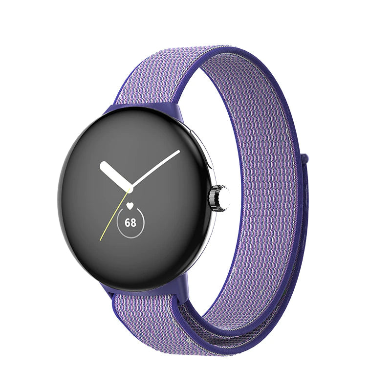 Google Pixel Watch with purple fabric sports loop band, black AMOLED display showing time and heart rate monitor