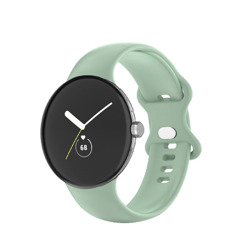 Google Pixel Watch with sage green silicone band and black minimalist dial display