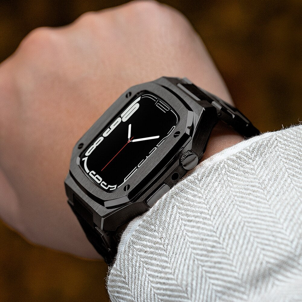 Black stainless steel luxury smartwatch with rectangular face and black sport band worn on wrist