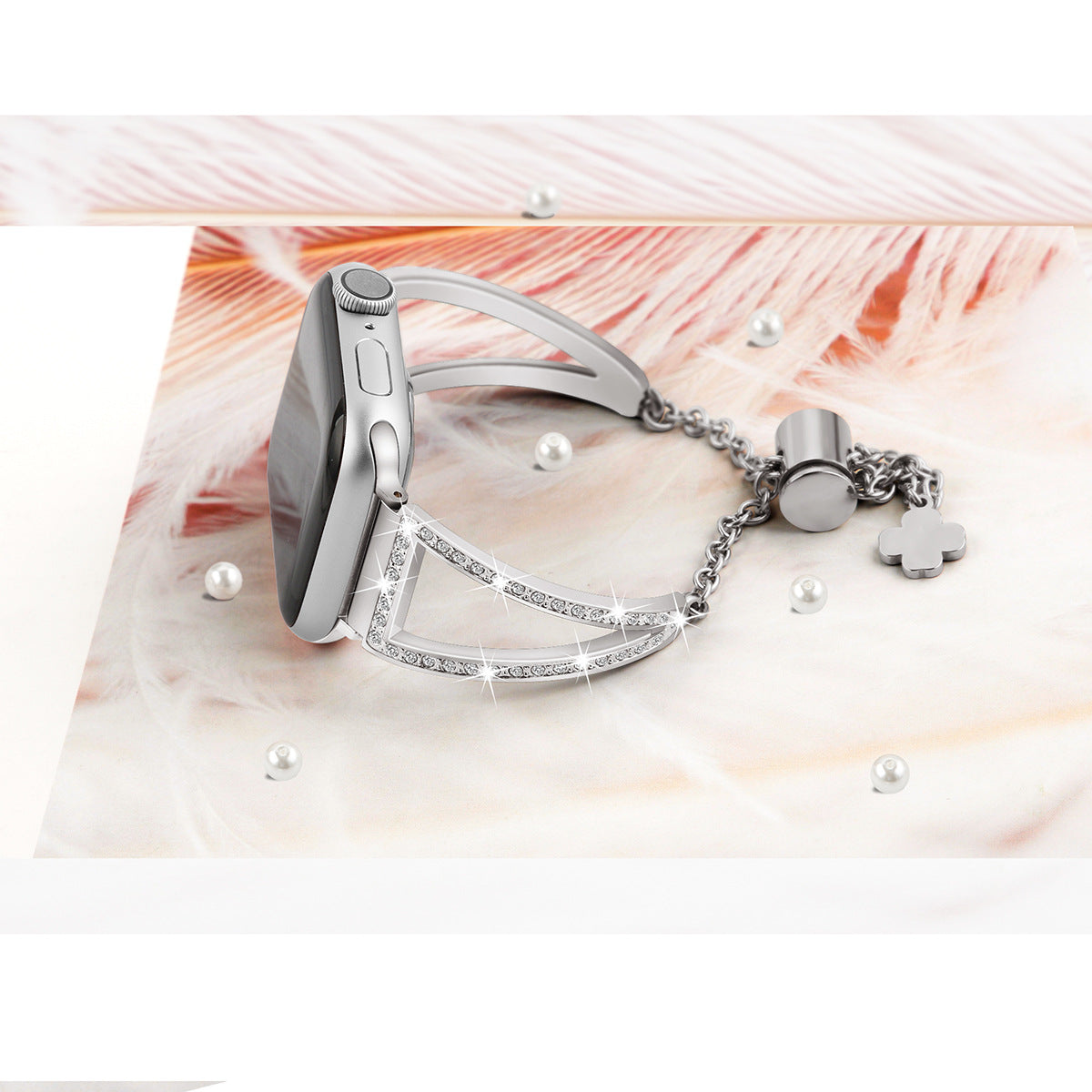 Silver stainless steel smartwatch with crystal-embellished nude shimmer bracelet and charm pendant on feathered background