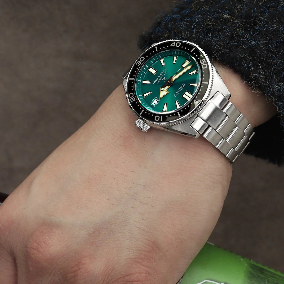 Seiko SBDC053 62MAS watch with turquoise dial and stainless steel Super-O Boyer bracelet worn on wrist