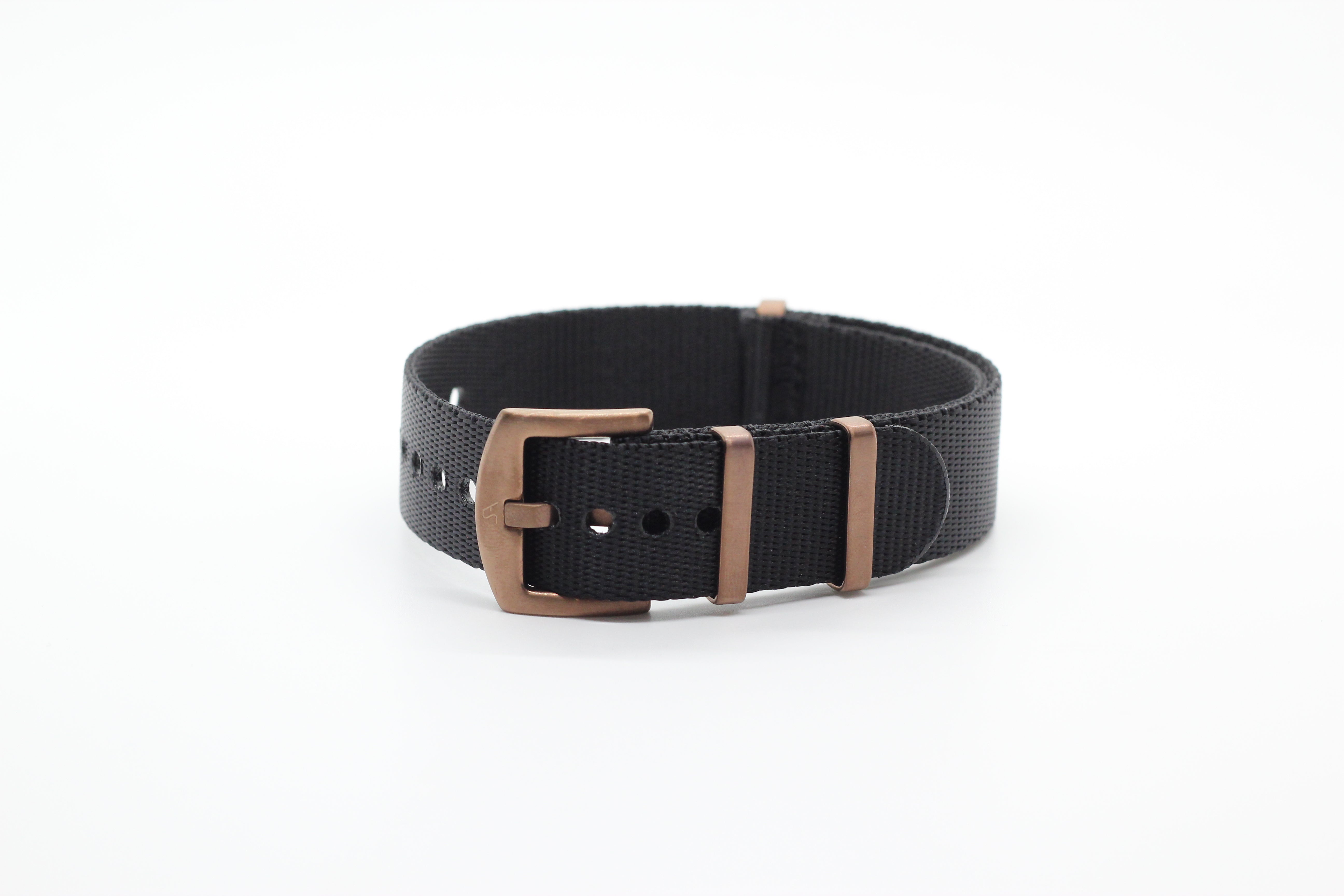 Black canvas military watch strap with bronze hardware and adjustable buckle closure
