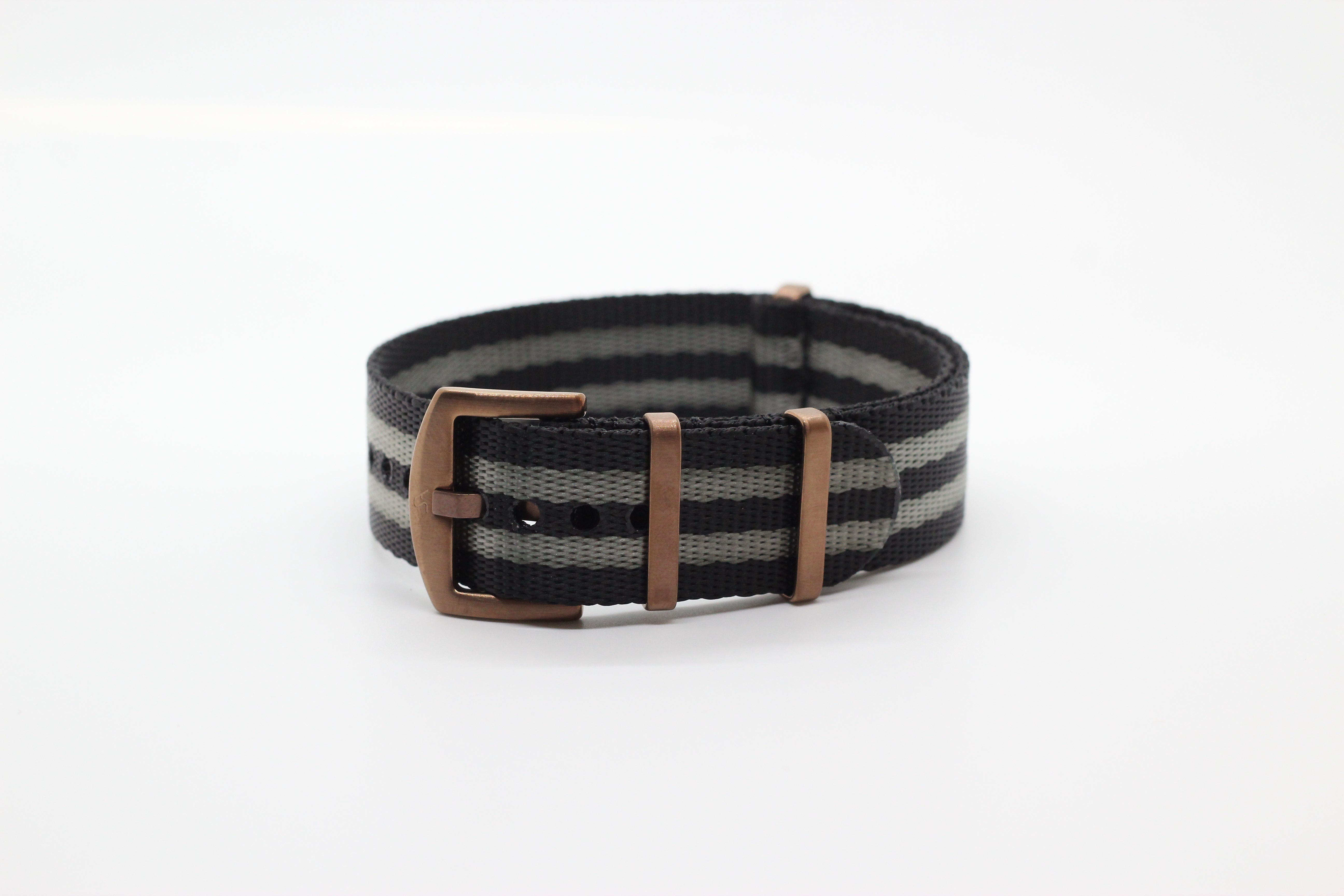 Black and grey striped fabric watch strap with bronze buckle and hardware, military-style design