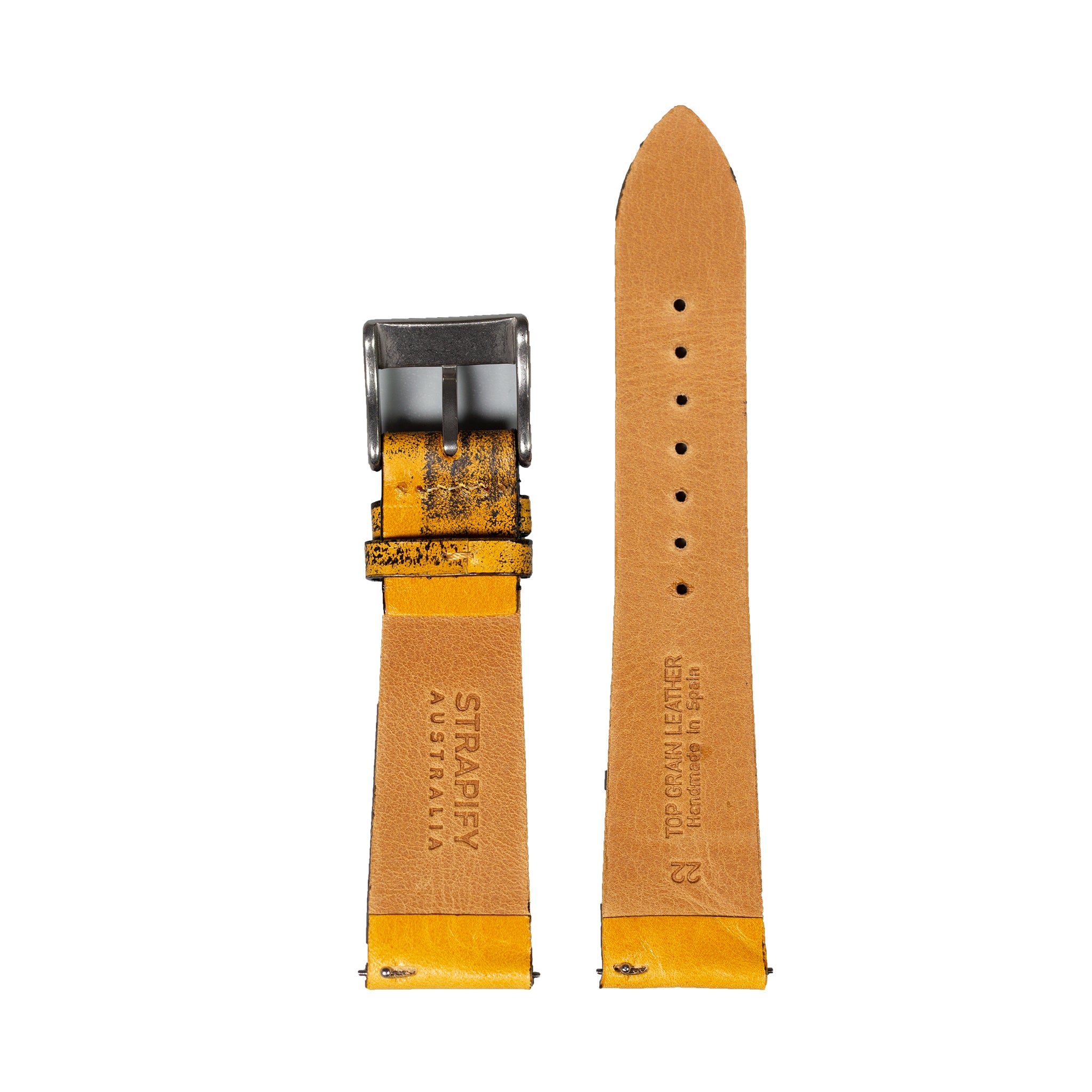 Vintage tan leather watch strap with yellow accent, quick release pins, gunmetal buckle, and distressed finish