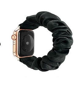 Gold Apple Watch with black velvet scrunchie loop band on white background