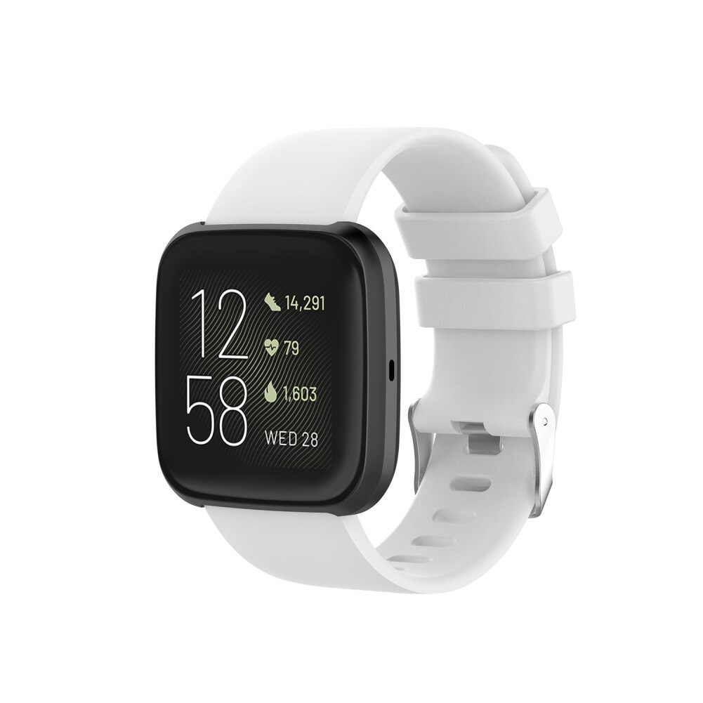 Fitbit Versa smartwatch with white silicone band displaying time, steps, heart rate and date on black square screen