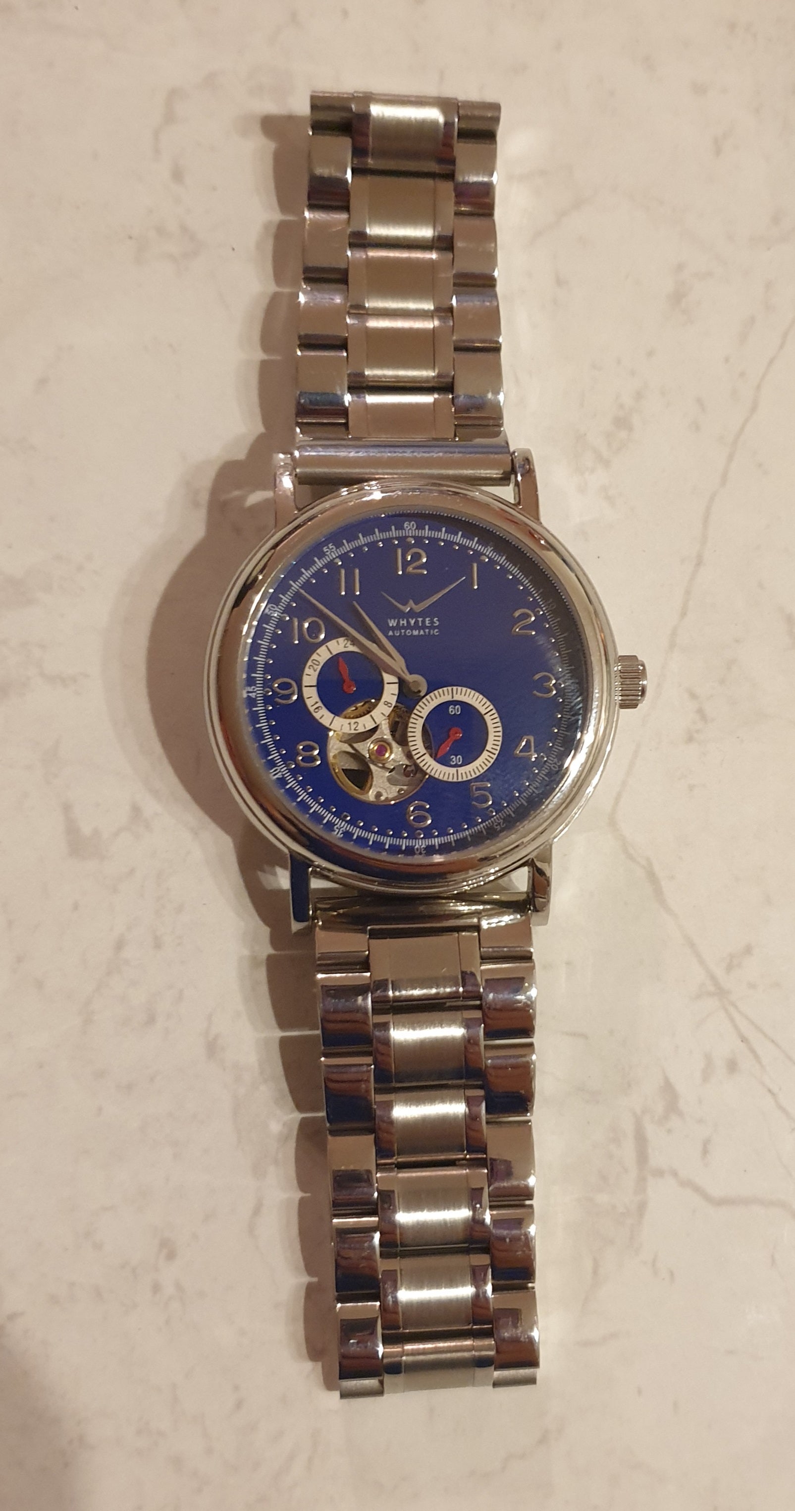 Whytes automatic watch with blue dial, dual subdials, and stainless steel link bracelet