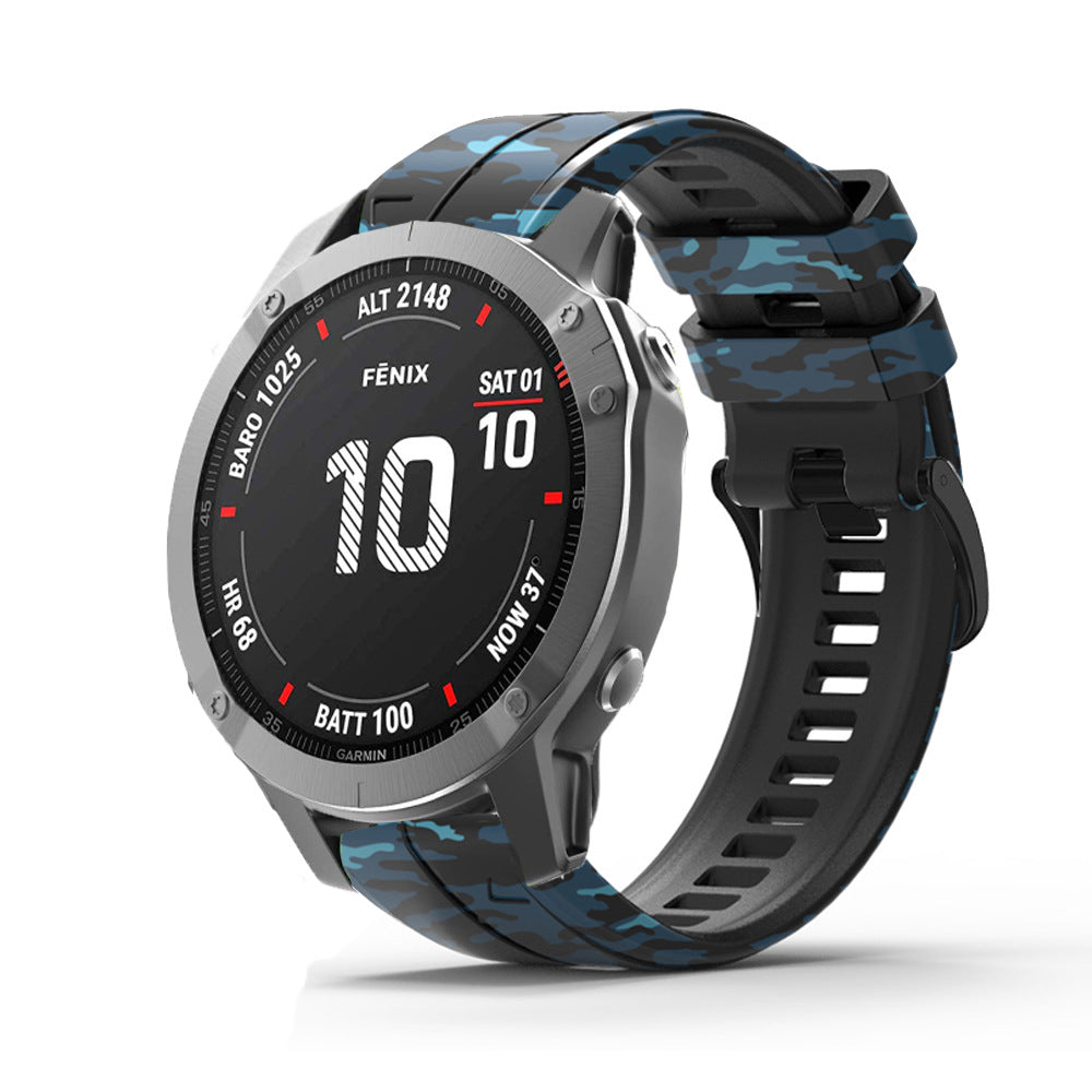 Garmin Fenix smartwatch with blue camouflage silicone QuickFit band and titanium case displaying altitude and battery stats