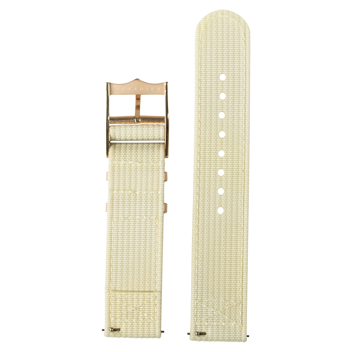 Beige canvas quick release watch band with bronze buckle and white adjustment holes, shown assembled and unattached