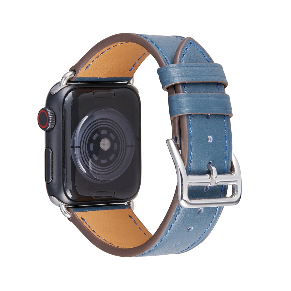 Blue leather Apple Watch band with tan inner lining, silver buckle and stitching detail on smartwatch