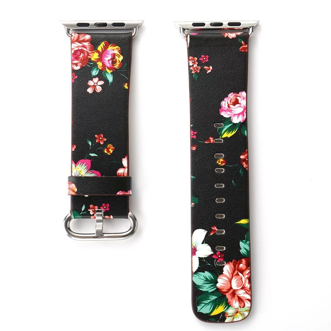 Black leather Apple Watch band with vibrant floral pattern featuring pink roses, red peonies, and white flowers on dark background