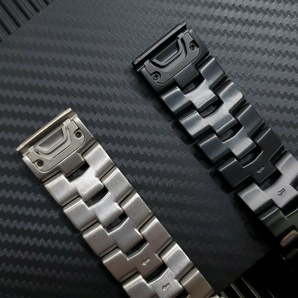 Titanium quick-release bracelet in silver and black with modular link segments and attachment loop on textured surface