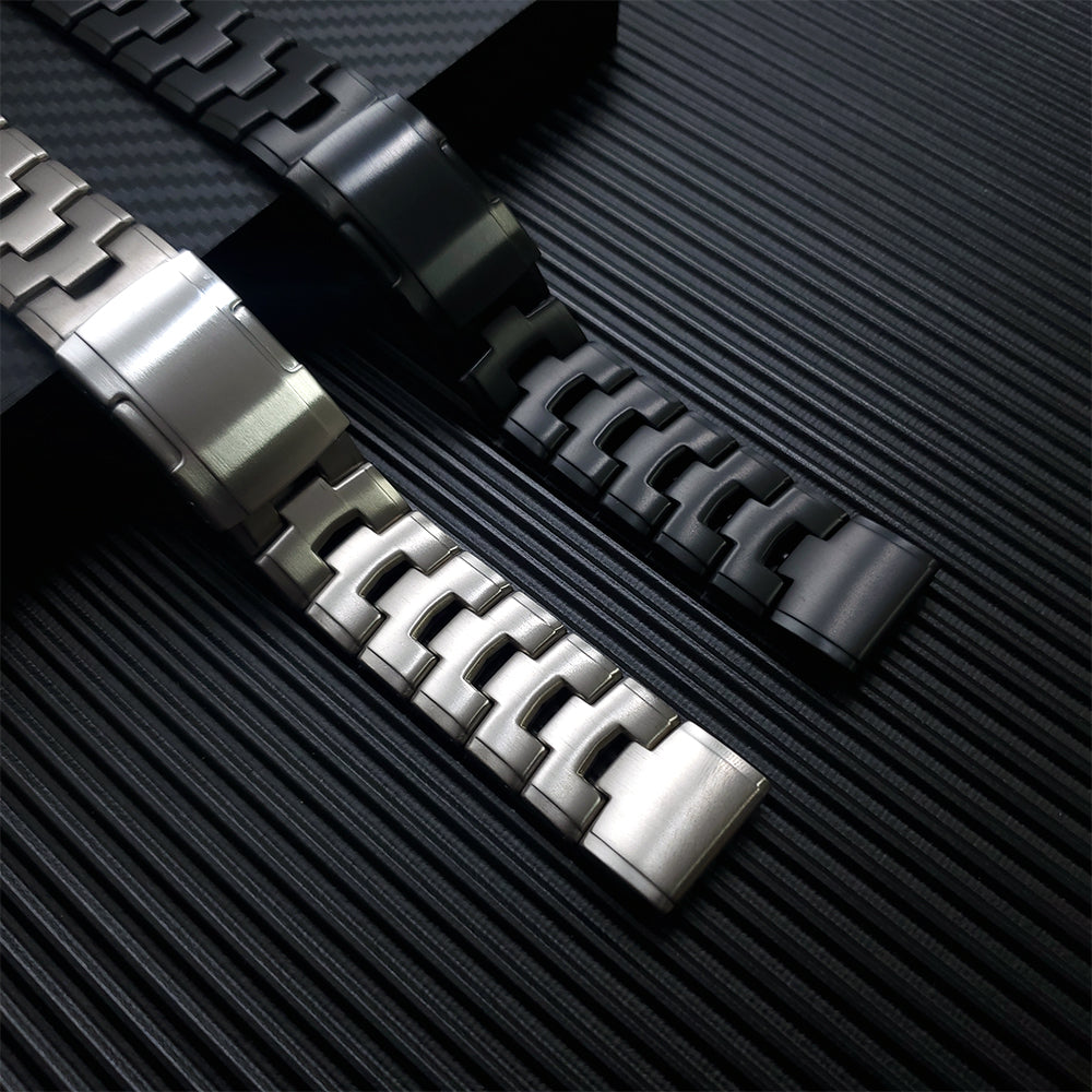 Silver and black titanium watch bracelets with quick-fit links displayed on textured background