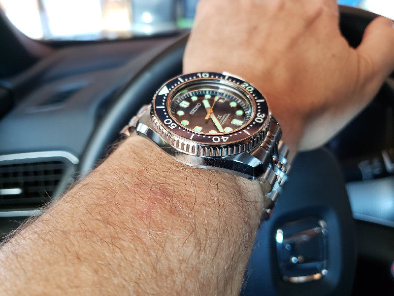 Strapcode Angus-J Jub steel bracelet on Seiko MarineMaster MM300 dive watch worn on wrist in car