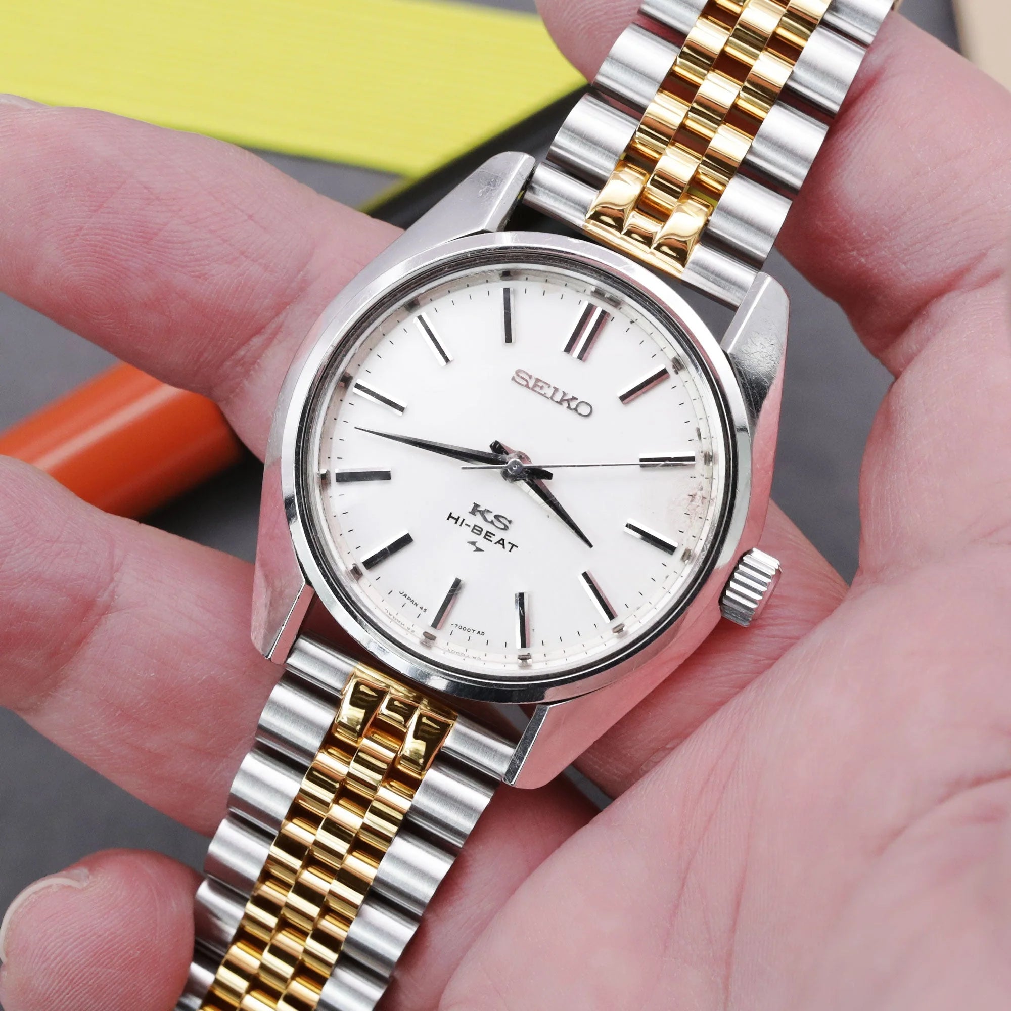 Seiko King Seiko Hi-Beat watch with two-tone silver and gold stainless steel jubilee bracelet and white dial held in hand