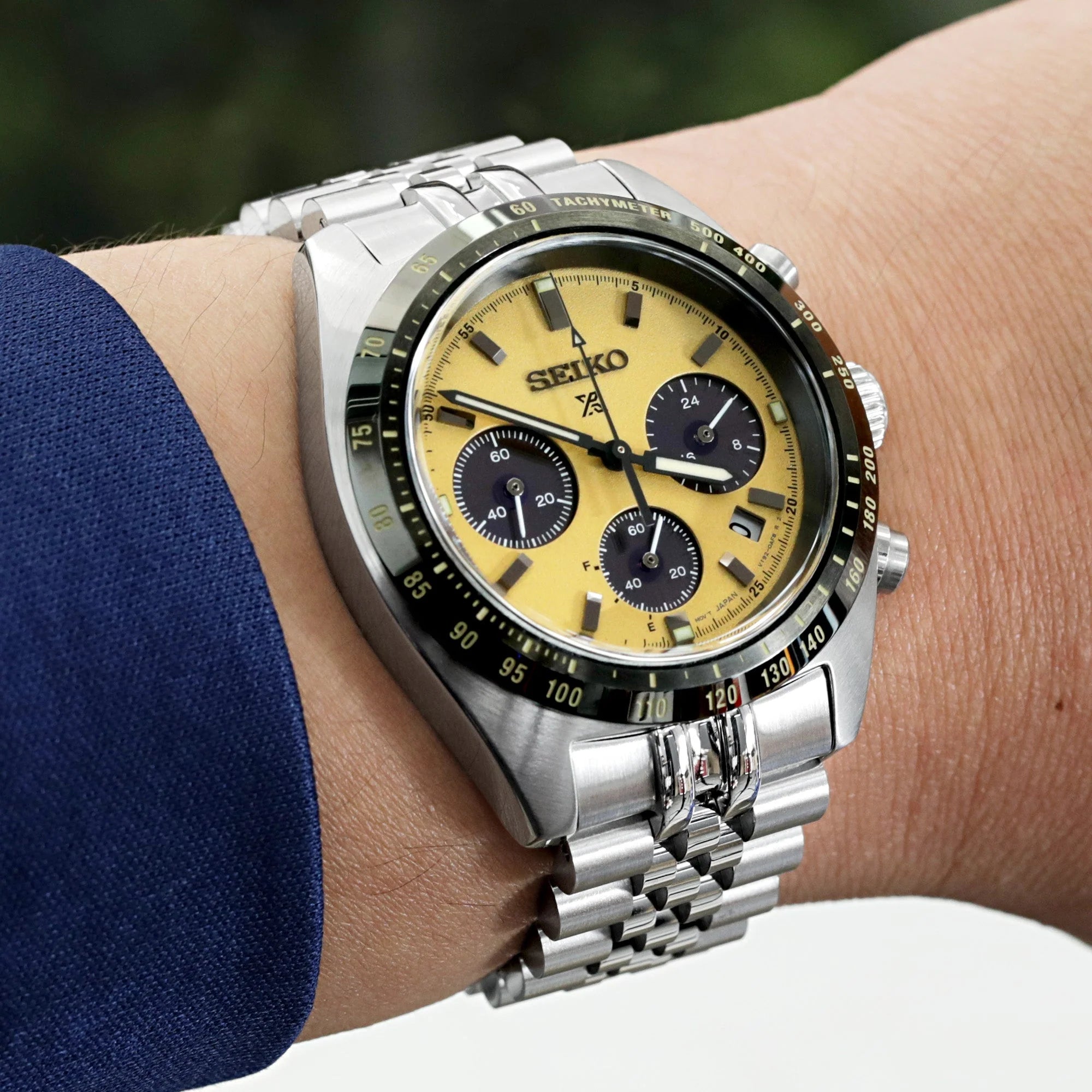 Seiko Speedtimer chronograph watch with yellow dial and stainless steel Super-JUB II bracelet worn on wrist