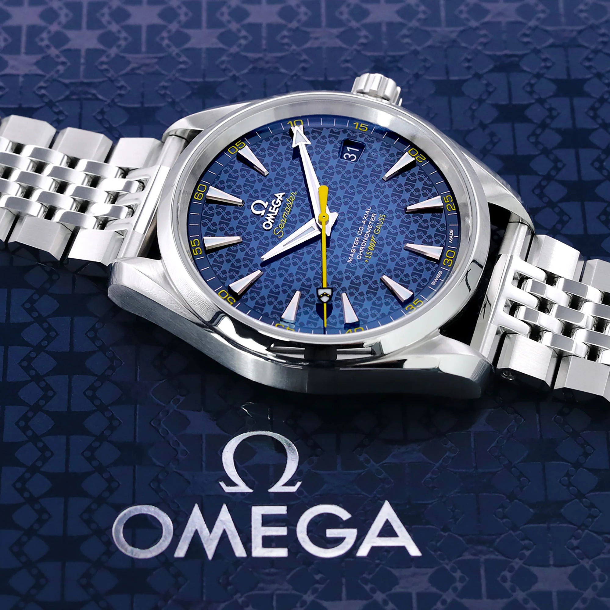 Omega Seamaster stainless steel watch with blue dial and matching metal bracelet on patterned background