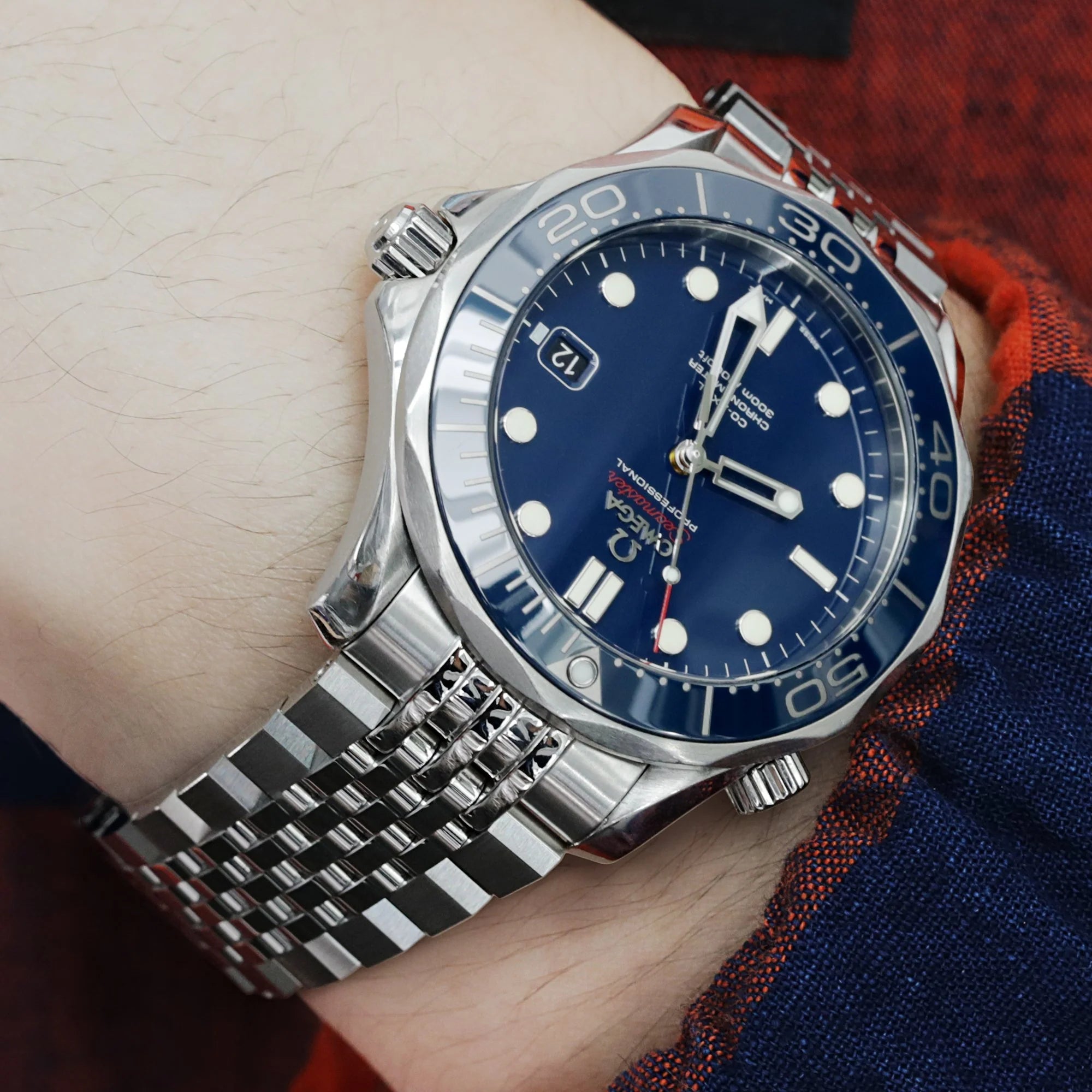 Stainless steel Asteroid bracelet fitted on Omega Seamaster 41mm watch with blue dial, shown on wrist