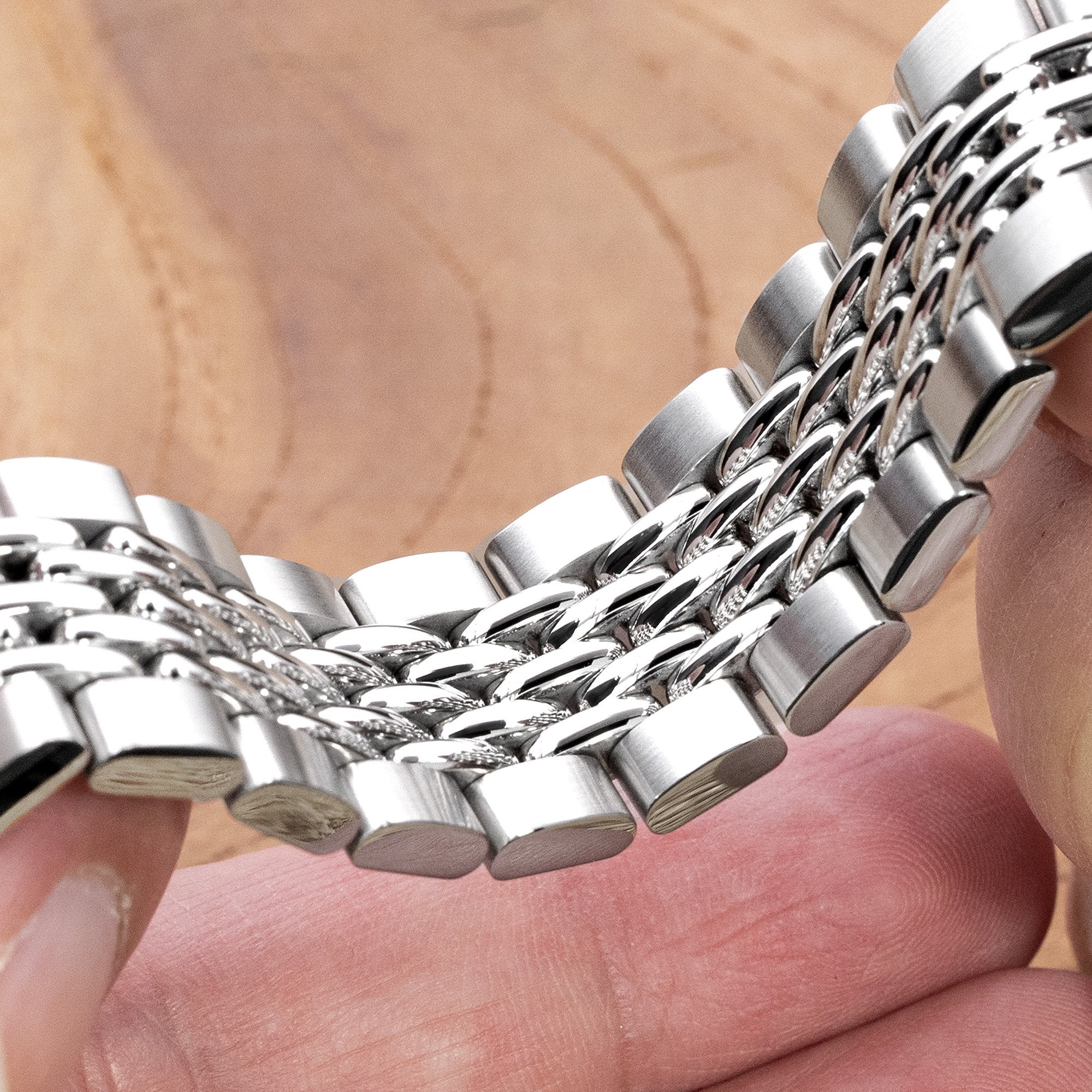 Stainless steel GOMA BOR bracelet with solid links displayed on wrist, showcasing polished and brushed finish details for Seiko 5 GMT watches