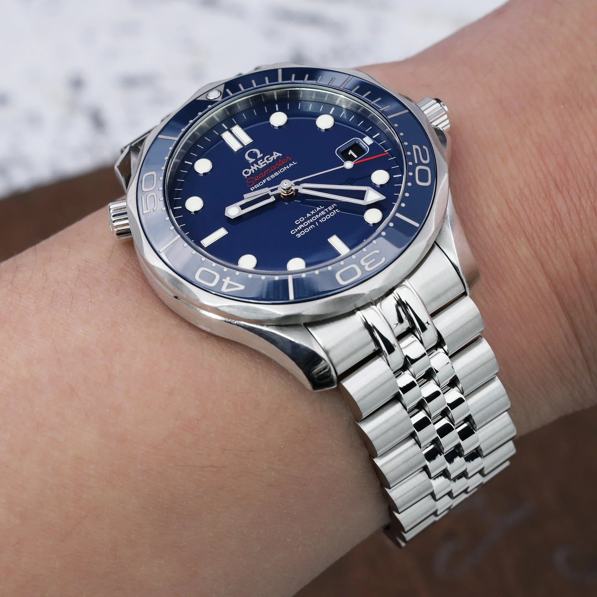 Strapcode Super-J Louis steel bracelet on Omega Seamaster 41mm watch with blue dial and white dot markers