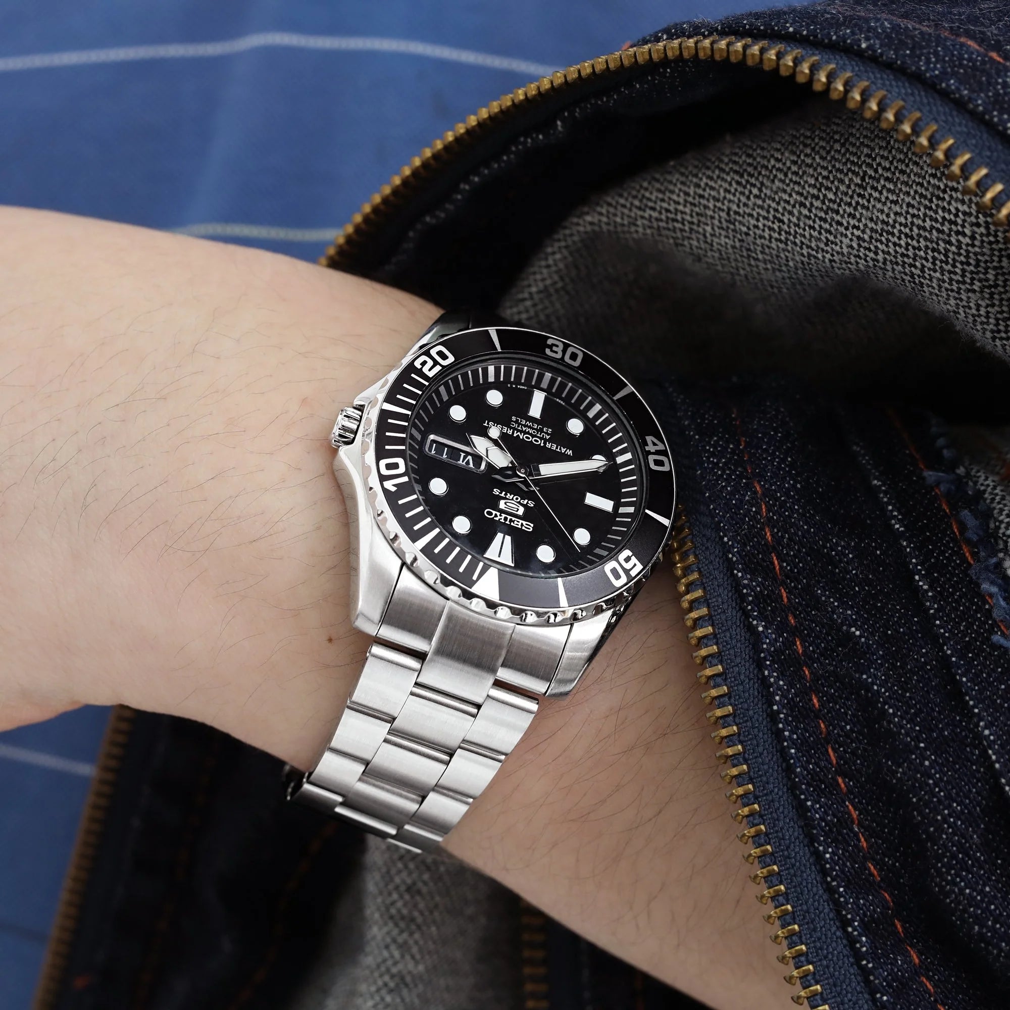 Strapcode Super-O Boyer bracelet on Seiko Sea Urchin SNZF17 dive watch with black dial, worn on wrist with blue jacket