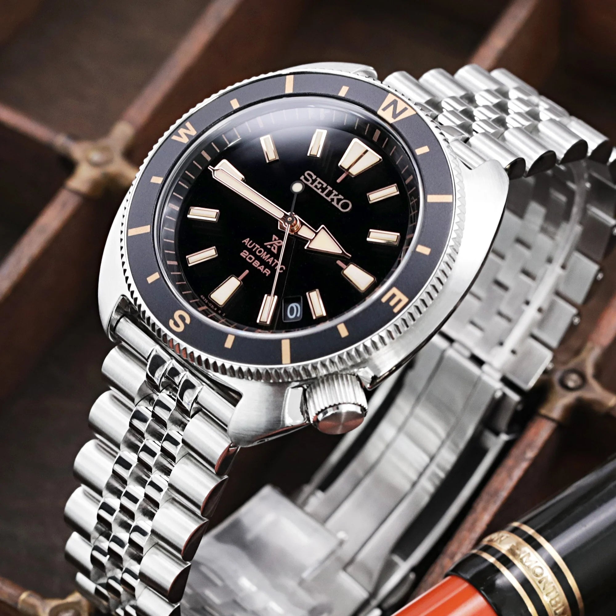 Seiko automatic dive watch with stainless steel jubilee bracelet and black dial with gold hour markers