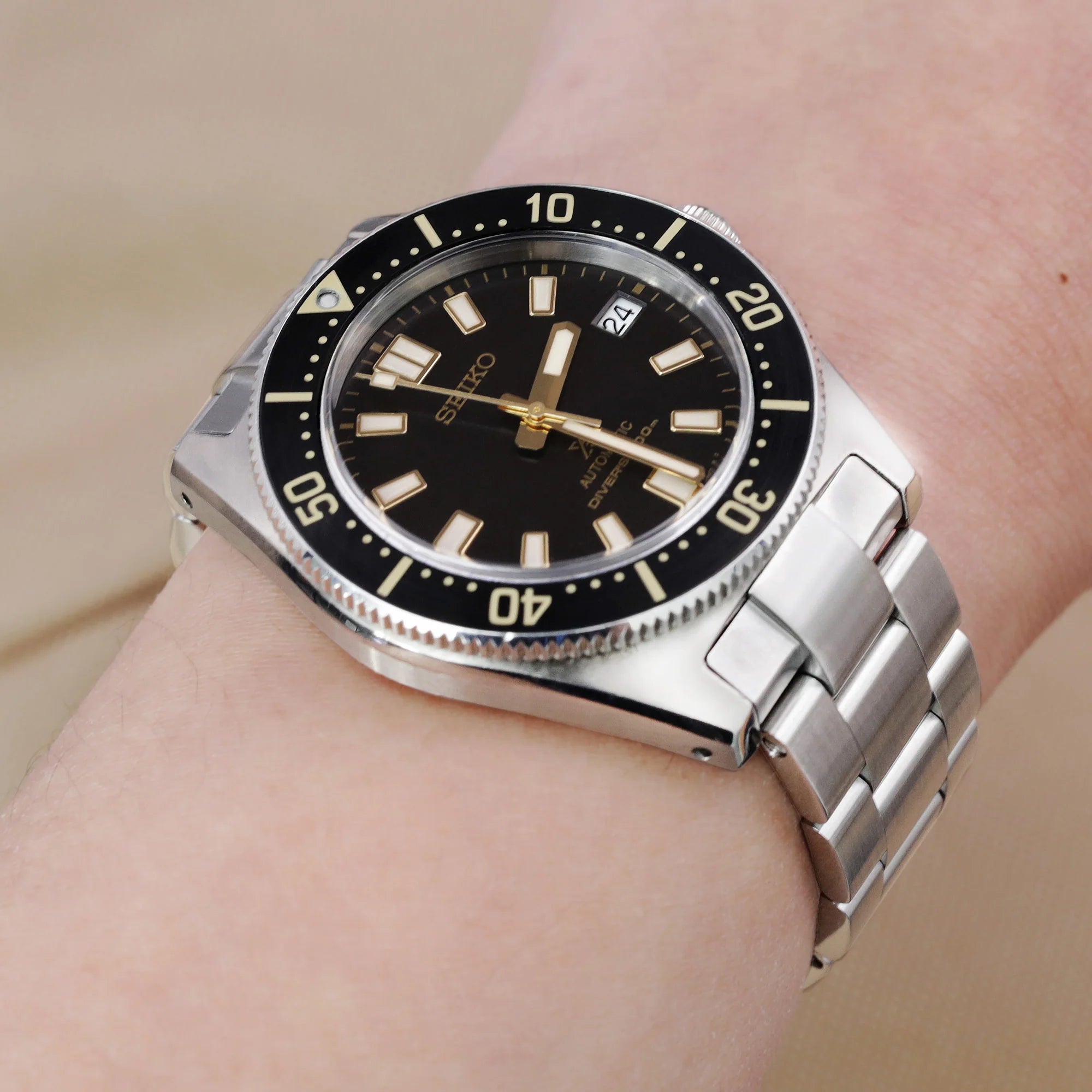 Seiko SPB143 63MAS dive watch with stainless steel Super-O Boyer bracelet on wrist, black dial with luminous markers and rotating bezel