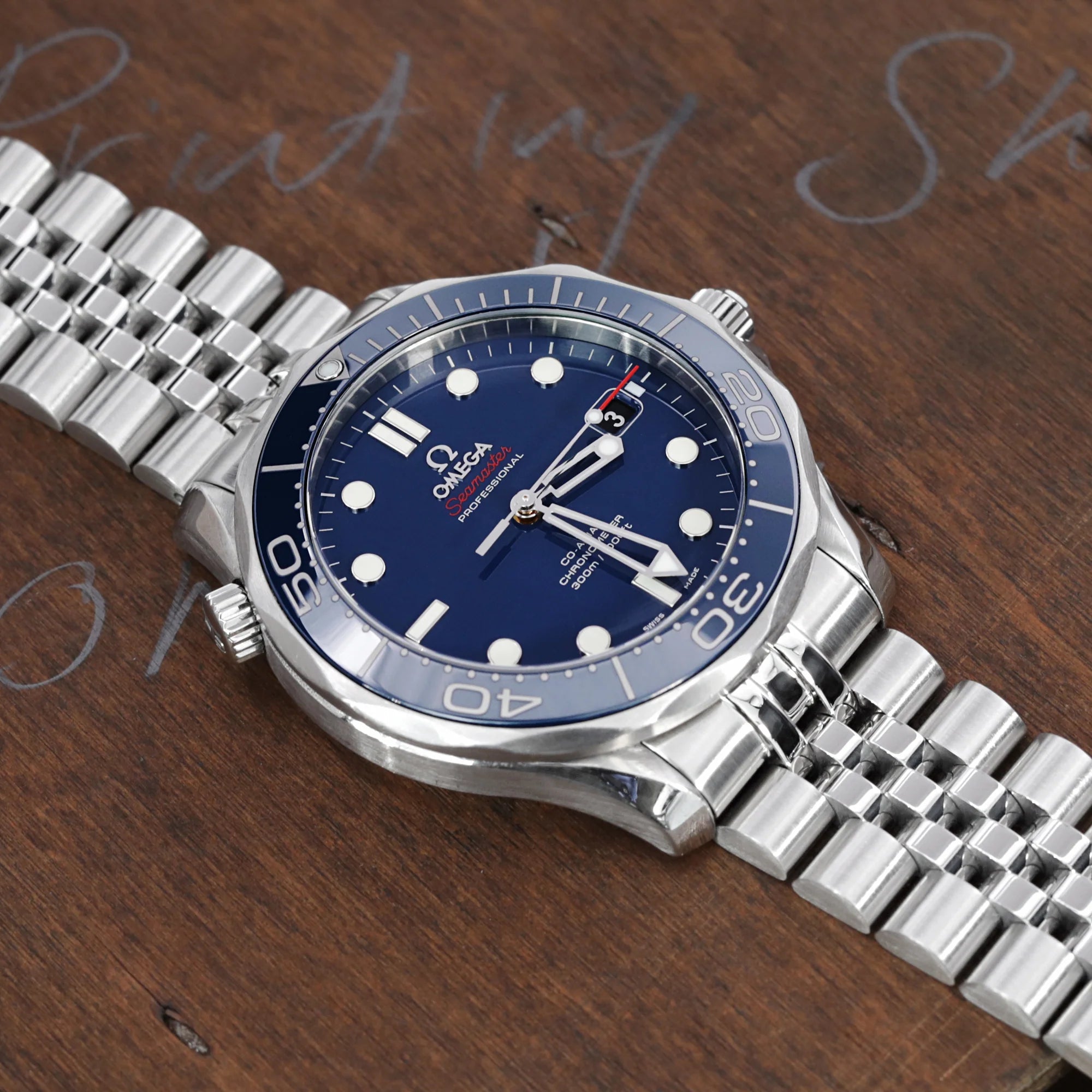 Stainless steel Super-J Louis bracelet for Omega Seamaster 41mm and Moonswatch watches with 20mm lug width on wooden surface