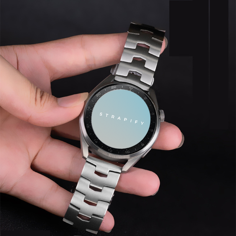 Titanium quick release smartwatch bracelet 22mm held in hand showing silver metal links and clasp