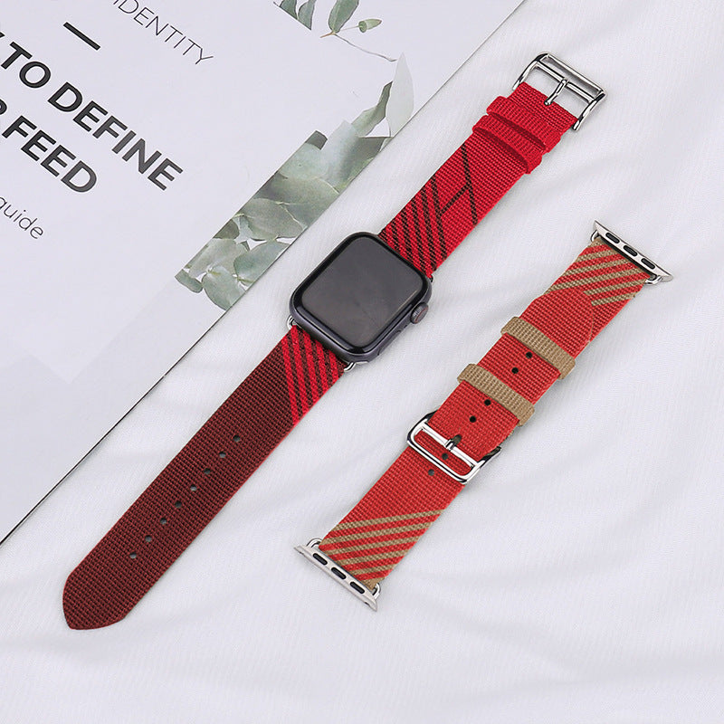 Red fabric Apple Watch band with striped pattern and silver connector, displayed with matching strap options on white background
