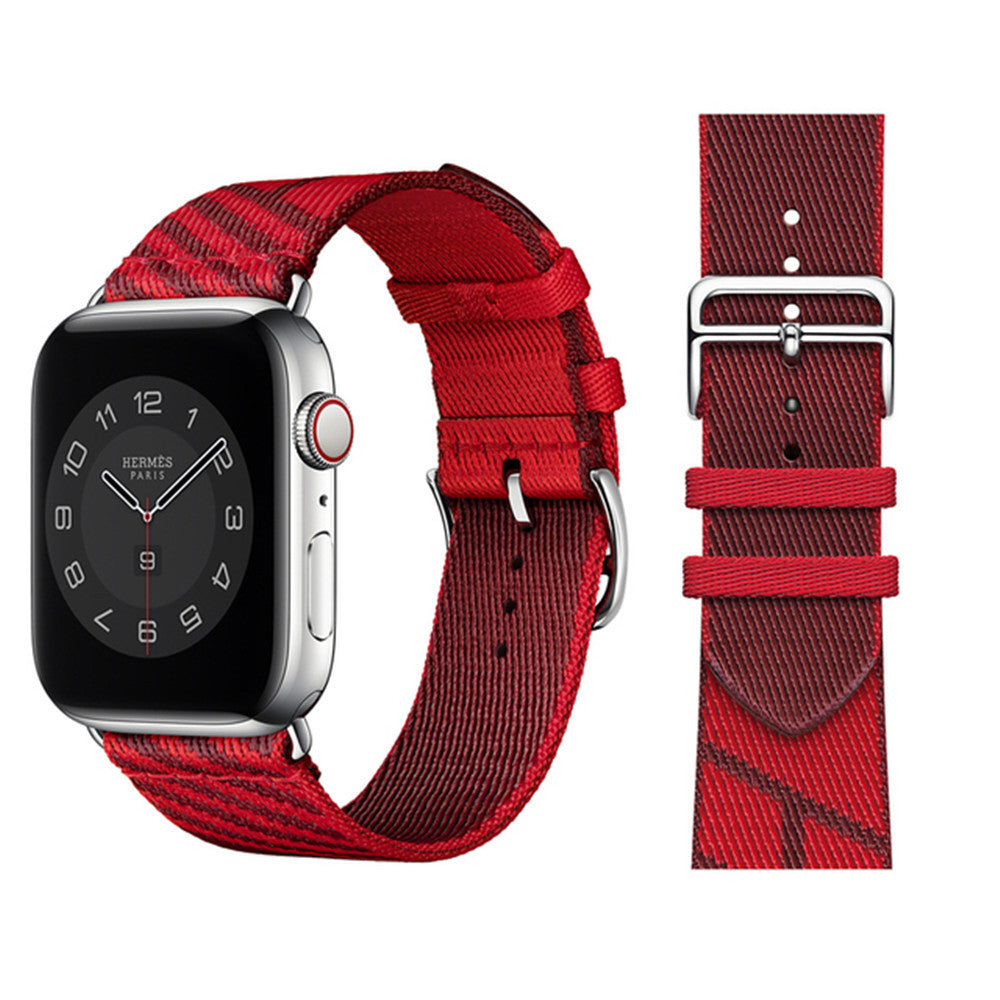 Hermès red textile watch band with silver buckle for Apple Watch, shown attached and separately