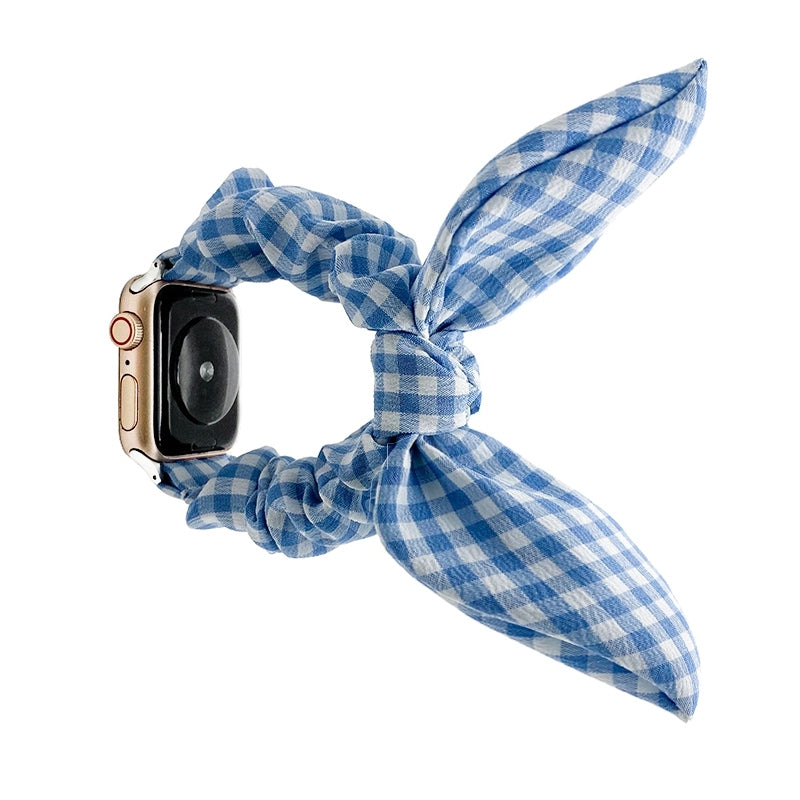 Gold smartwatch with blue and white gingham fabric scarf-style loop band accessory