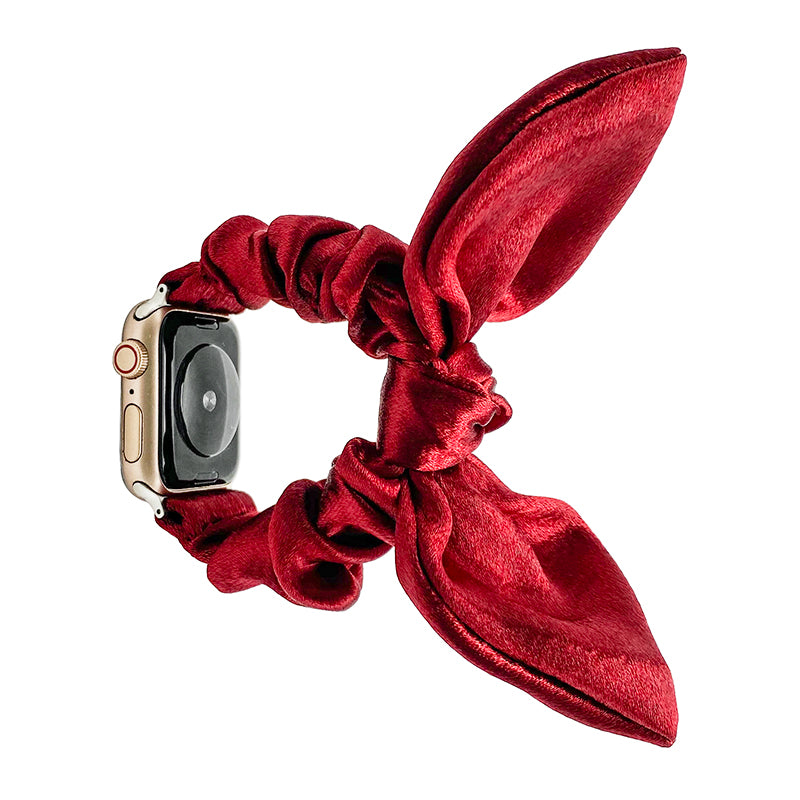 Red velvet ribbon loop Apple Watch band with gold case smartwatch displayed on white background
