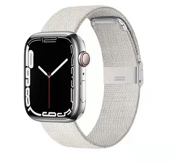 Silver stainless steel smartwatch with black face displaying time, paired with light gray woven canvas band and metal clasp closure