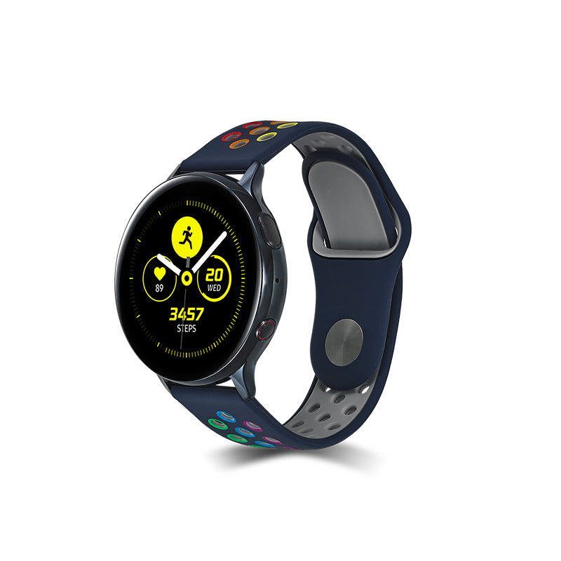 Black smartwatch with rainbow sports silicone band displaying fitness tracking interface with step counter and workout metrics