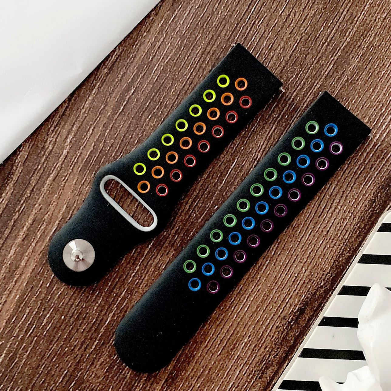 Black silicone smart watch bands with quick release clasps, featuring gradient rainbow neon-colored ring designs in yellow, orange, red, green, blue, and purple