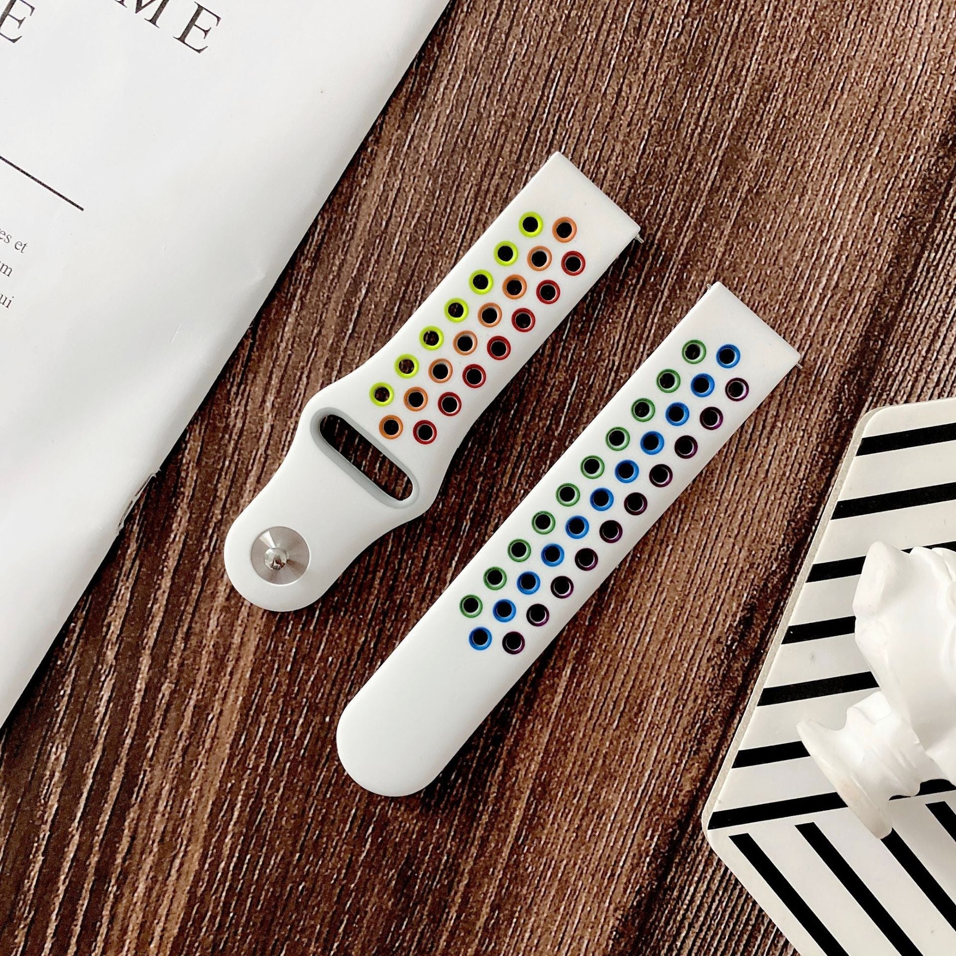 White silicone sports watch band with quick release mechanism and color-coded eye design elements in rainbow hues