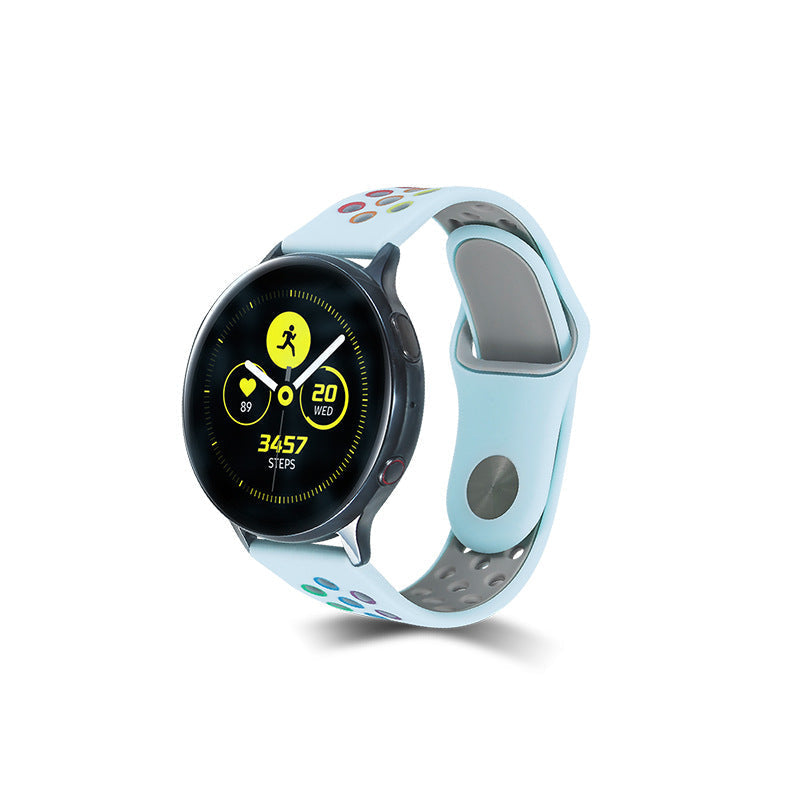 Black smartwatch with colorful dot pattern light blue silicone sport band, displaying fitness tracking metrics and 3457 steps