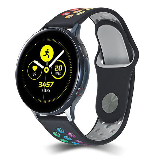 Black smartwatch with yellow AMOLED display showing fitness metrics, rainbow-accented black silicone sport band with quick release