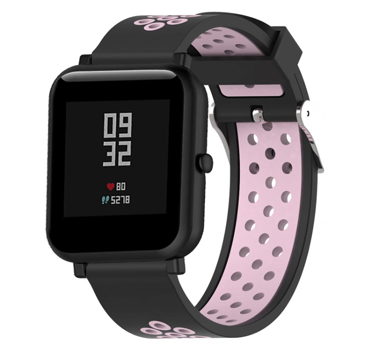 Black smartwatch with pink perforated silicone sports band, quick release strap, heart rate and step counter display