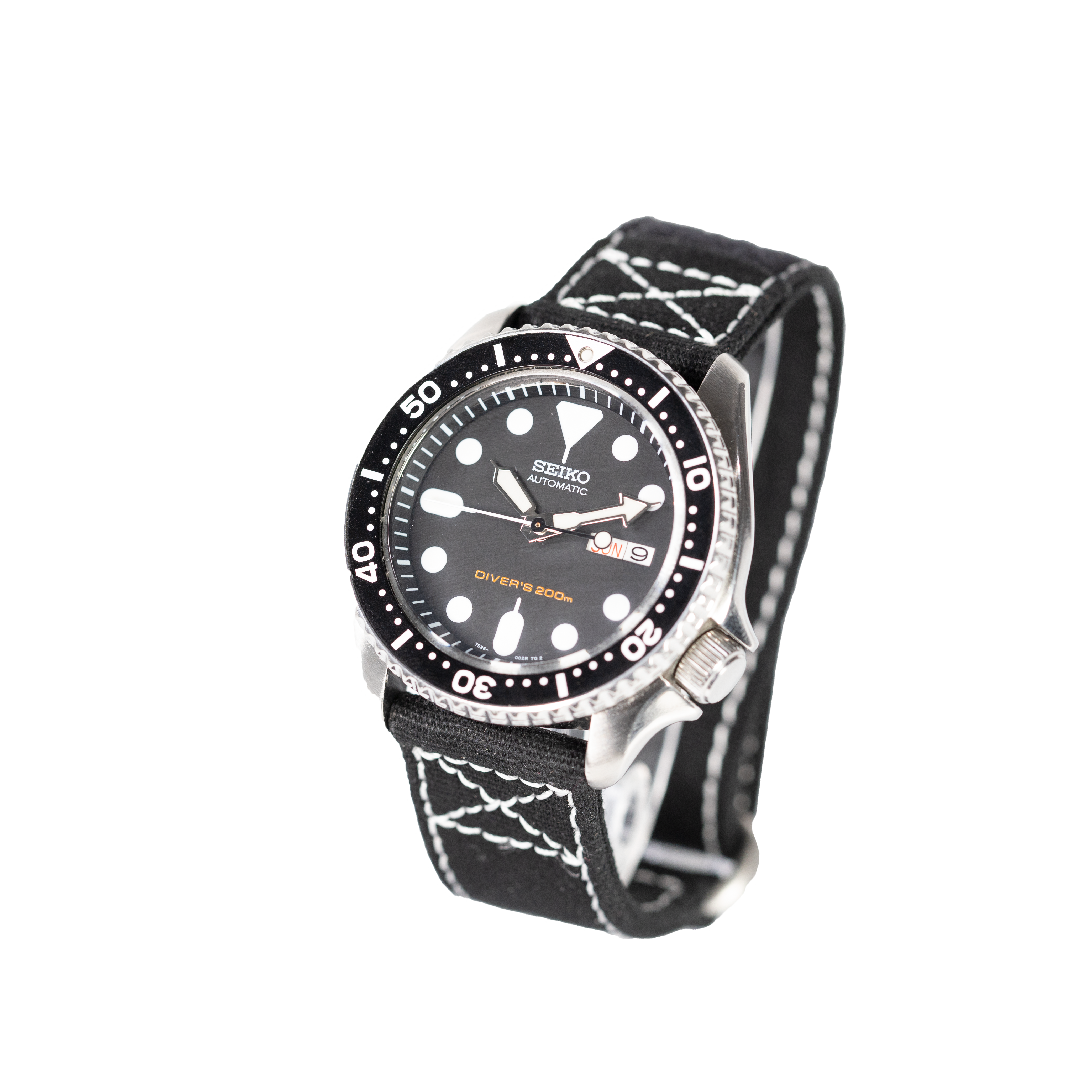 Seiko automatic dive watch 200m with black dial, rotating bezel, steel case and black fabric strap with white stitching