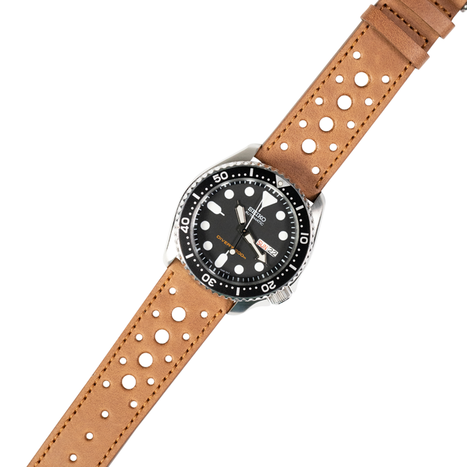 Stainless steel dive watch with black dial and tan perforated leather quick release strap