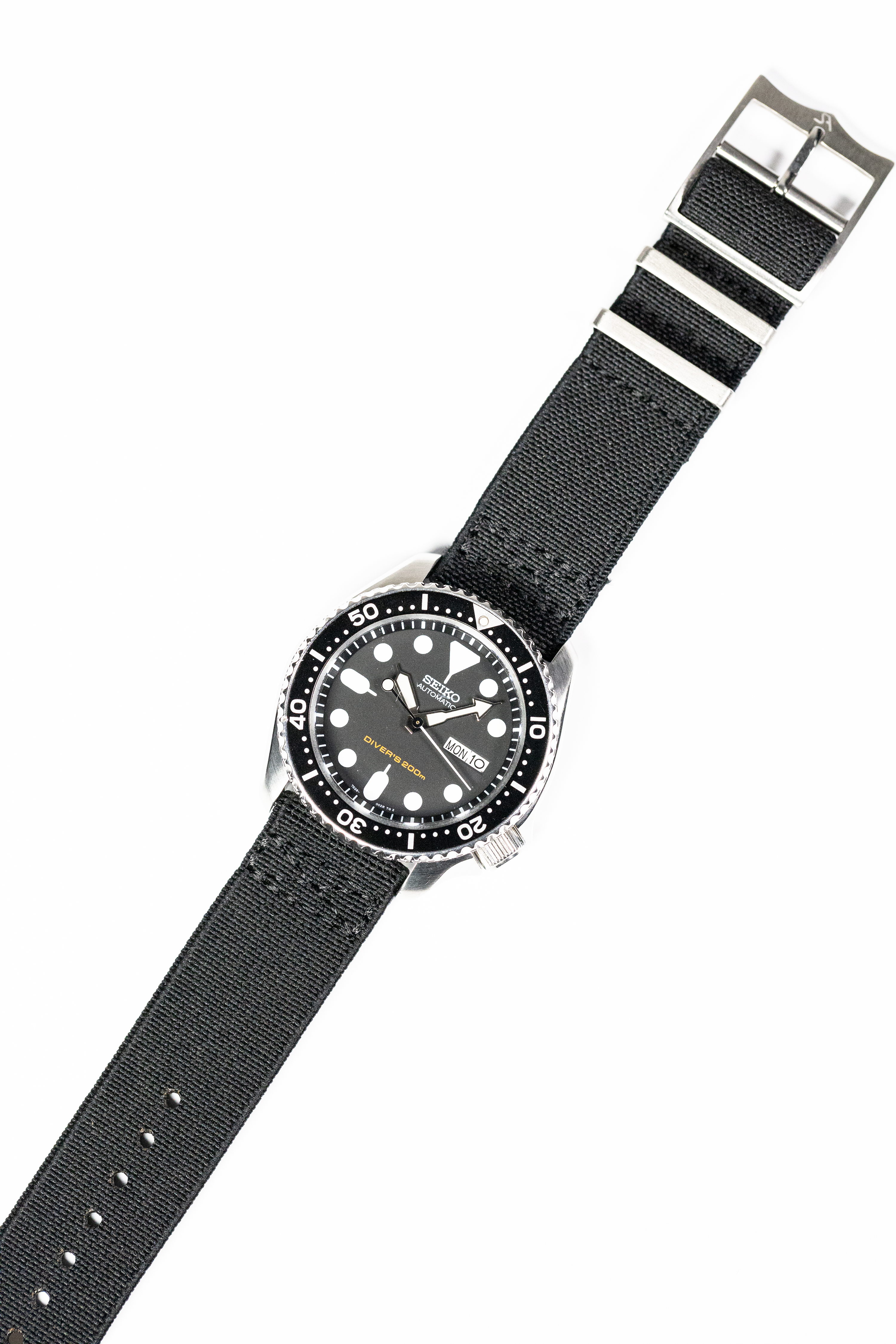 Black fabric quick release watch strap with striped design and silver buckle hardware for dive watches